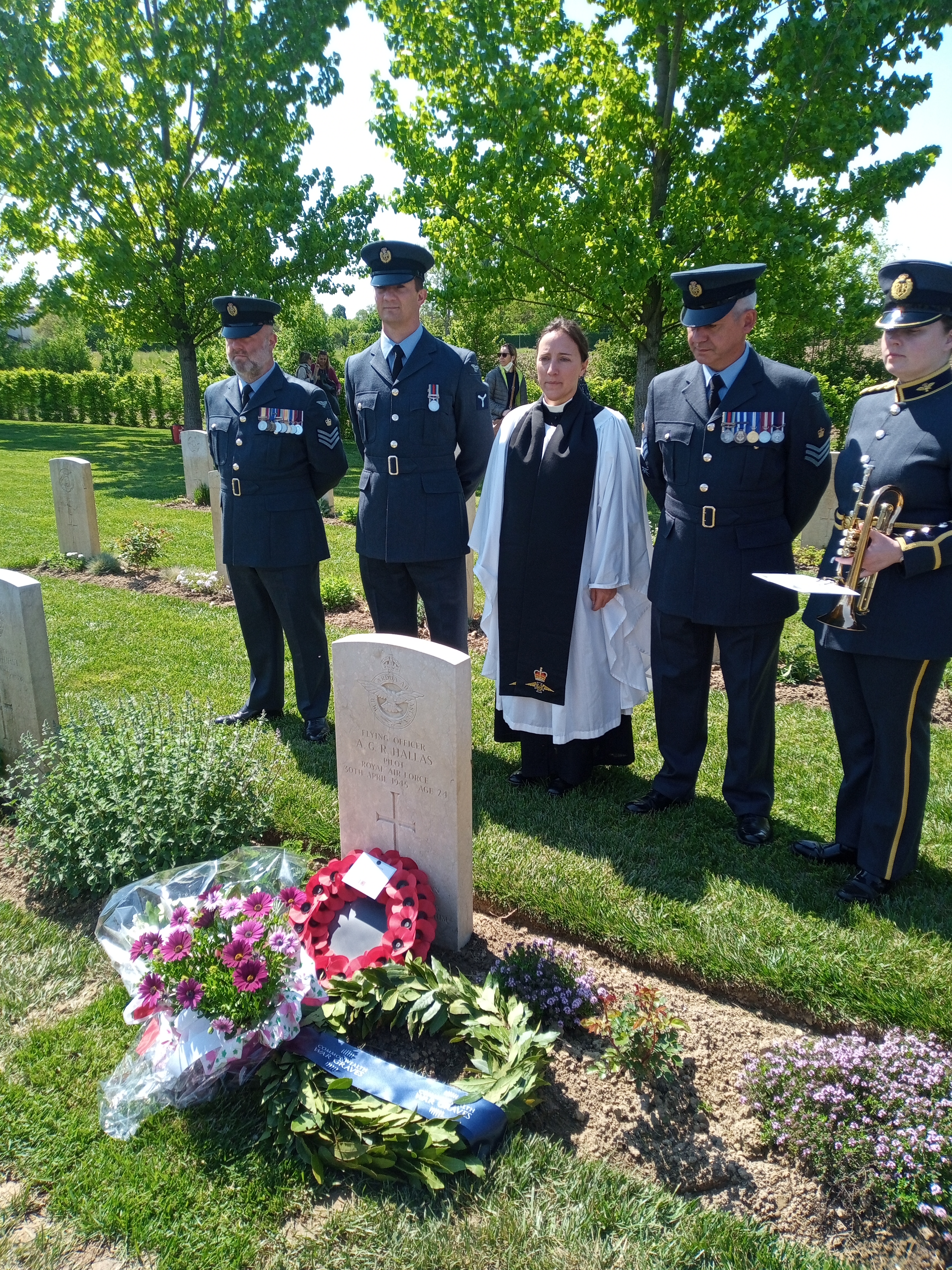 Personnel and Reverend stand by memorial.